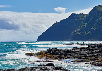 Windward Oahu shoreline and surf breaking over rocks at makapuu