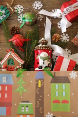 Christmas gift bag with gifts and Christmas tree and snowflakes on wooden background. Christmas and New Year concept. Flat lay. Top view. Copy space for text. Pattern, card, postcard. Vertical photo.