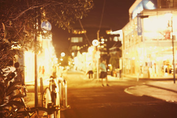 People walking at footpath in  night time with light bokeh.Crowded street in Japan, blurred background in japan .for background usage.