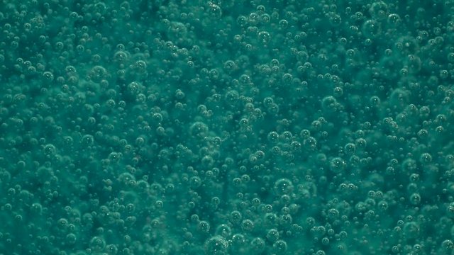 Mesmerizing blue bubbles floating in slow motion