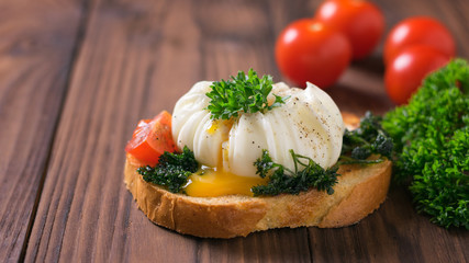 The resulting yolk from the poached egg on a piece of bread.