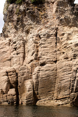 Cliffs and rock formations along the coastline of the Coromandel Peninsula
