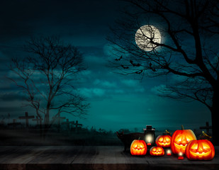 Dark night haunted graveyard and the moon with branches tree and flying bats on Halloween day and Jack-o-lantern on the wood plank board with lamp and red candle and the black cat.