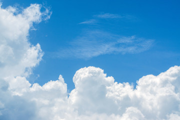 Naklejka na ściany i meble Beautiful view of white fluffy clouds on a clear blue sky background. Nature weather on the vast cloud blue sky. Sky daylight in summer. Natural background with copy space. Element of design.