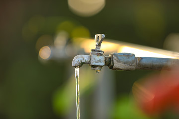 Water drop form old iron cock 