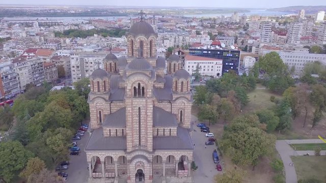 Revealing 4k aerial shot of Crkva Svetog Marka in Tasmajdan park, Beograd