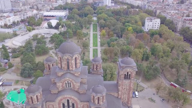Stunning establishing fly over Tasmajdan park and St Mark Church, Belgrade