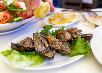 Squeezing a lemon on Midye dolma