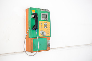 Coin-operated public payphone and white background