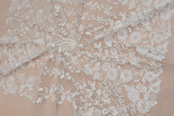 Obraz premium Texture lace fabric. lace on white background studio. thin fabric made of yarn or thread. a background image of ivory-colored lace cloth. White lace on beige background.