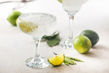 Refreshing Homemade Classic Alcoholic Margarita Cocktail with Lime and Salt on light background