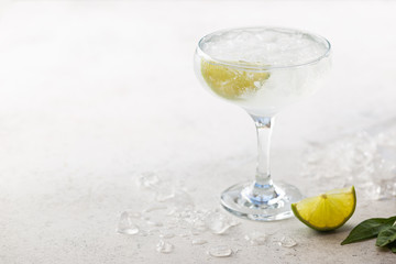 Refreshing Homemade Classic Alcoholic Margarita Cocktail with Lime and Salt on light background