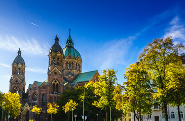 Isar and autumn landscape nerxt to Sankt Lukas church in Munich, Bavaria, Germany