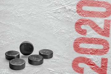 Pucks on the ice of the hockey arena