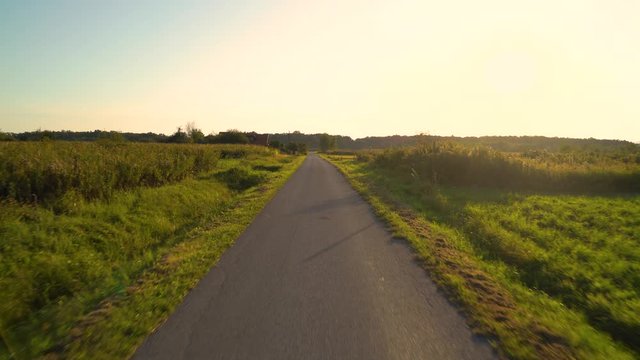 Point of view riding bicycle in the countryside during golden hour, Croatia.