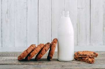 milk and cookies on a wooden table