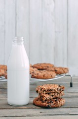 milk and cookies on a wooden table