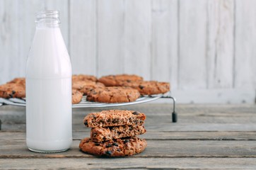 milk and cookies on a wooden table