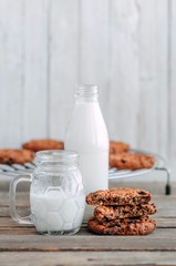 milk and cookies on a wooden table