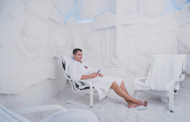 A young man is resting in the salt room, Spa treatments for men with respiratory disorders, inhalation Procedure in the Olean grotto