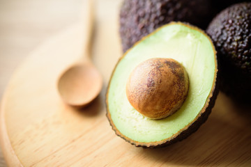 Close up of avocado fruit with spoon ready to eating