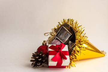 Golden bag with Christmas toys and gifts on a light background