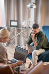 Top view of psychoanalyst with laptop talking with patient