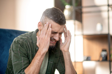 Man feeling bad while sharing his thoughts with psychoanalyst