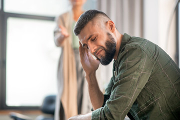 Man having awful headache while having psychological investigation