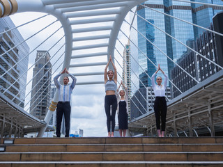 Young woman and friend doing yoga outdoors in a city,meditation in a modern city