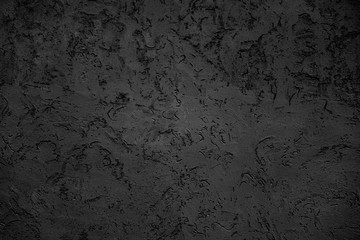 Rough dark relief stucco wall texture background. blank for designers