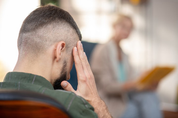 Close up of man touching head while suffering from headache