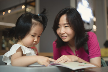 concept of Asian mother and 2 years old spending time together at home.