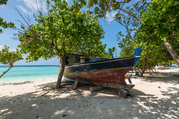 Naklejka na ściany i meble Colorful wooden boat on the coast of the Gulhi island, Maldives, Indian Ocean. Tropical holidays.