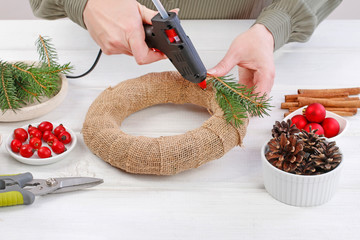 Woman shows how to make classic Christmas door wreath