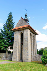 SKOMIELNA CZARNA,POLAND - SEPTEMBER 29, 2019: Old stone belfry in the garden of the church