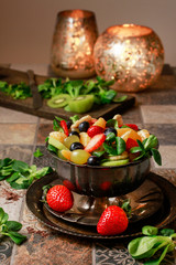 Fruit salad with kiwi strawberries and oranges.