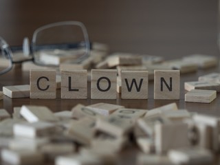 The concept of Clown represented by wooden letter tiles
