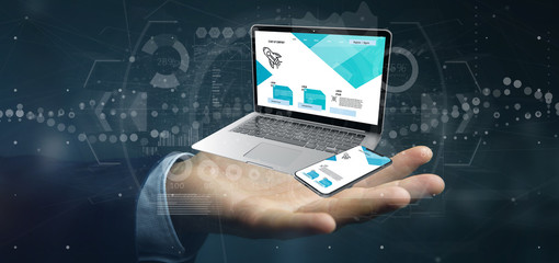 Businessman holding a Laptop and a smartphone - 3d rendering