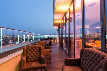 Interior of a rooftop hotel bar restaurant terrace - obrazy, fototapety, plakaty