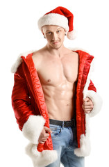 Young athletic Santa Claus on white background