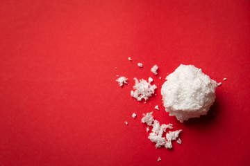 Christmas Snowball made of eco artificial snow on the red background