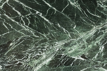 Fototapeta na wymiar The dark green marble. Facing stone. Texture