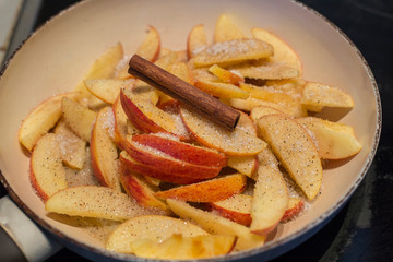 Caramelized apples close up in pan top view