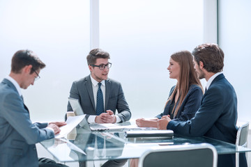businessman discussing something with employees at a meeting