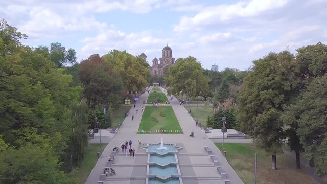 Stunning long 4k aerial flight shot over Tasmajdan Park and St Marko church in Belgrade