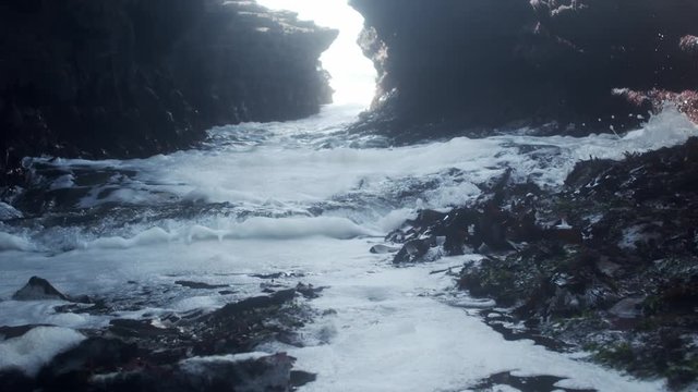 Close up of waves crashing on stones in Churchtown, Wexford, Ireland.