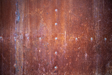 Rusty texture. Rusty metal background. Through a rusted metal sheet.
