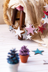 Christmas pinecone tree and Star christmas wreath in soft colors over stool with a wool blanket.Warm Scene Christmas Decoration