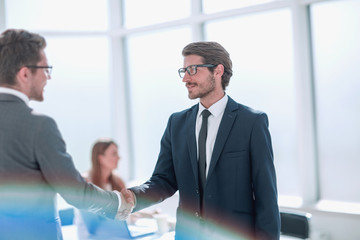 business people shaking hands standing in the office